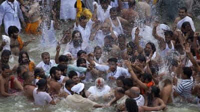 Indian Sadhus, or Hindu holy men, surround their guru, center, during a bath in the Godavari River. Tsering Topgyal / AP