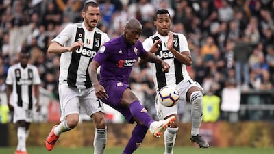 Fiorentina midfielder Bryan Dabo (c) challenges Juventus defenders Leonardo Bonucci and Alex Sandro. AFP