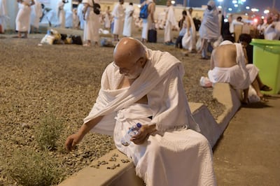 A Muslim pilgrim collects pebbles at Muzdalifah. AFP