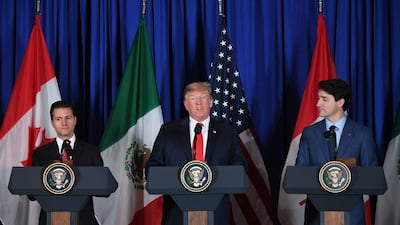 Mexican resident Enrique Pena Nieto, President Trump and Canadian Premier Justin Trudeau at the signing of the new North American Free Trade Agreement. Mr Trump called the earlier 1994 pact a job-killing disaster and had vowed to replace it. AFP