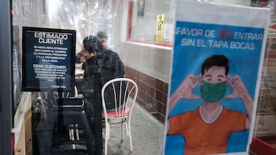 People eat at a restaurant, in a neighbourhood among those that have seen some of the highest number of city Covid-19 deaths, in the Queens borough of New York City. AFP