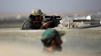 Rebel fighters stand on a lookout point in Aleppo, Syria. Khalil Ashawi / Reuters