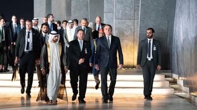 Brazilian President Jair Bolsonaro, second right, is received by Sheikh Khalifa bin Tahnoun, Executive Director of the Martyrs' Families' Affairs Office, at Wahat Al Karama on Saturday. Wam