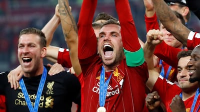Liverpool's Jordan Henderson celebrates lifts the trophy. Reuters