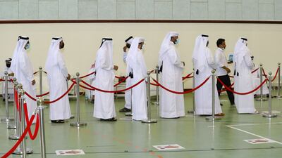 Voters line up at a polling station in Qatar's first legislative elections for two-thirds of the advisory Shura Council. AFP