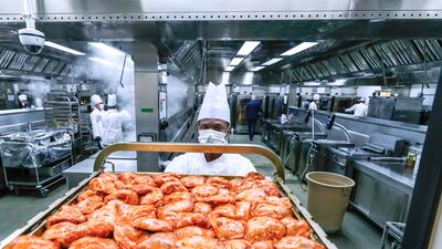 The marinated chickens are put on trays and taken to another kitchen to be roasted.