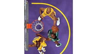 Tony Allen, 42, of the Boston Celtics attempts a shot against Kobe Bryant, left, and Derek Fisher.