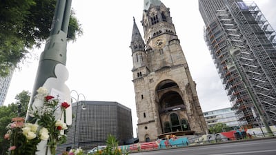 Flowers laid in tribute to the victims are seen on the pavement near the scene of an incident in which a car rammed into a group of visitors, in Berlin, Germany, last week. Reuters