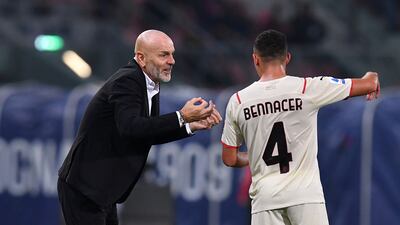 AC Milan coach Stefano Pioli speaks to Ismael Bennacer during the match. Reuters