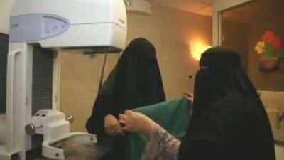 Volunteers examine a mammography machine in the Breast Cancer Awareness Mobile Clinic.