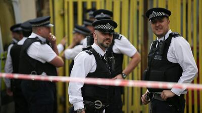 Police officers stand on duty in the east London suburb of Barking on June 5, 2017, following a dawn raid on a property as their investigations continue two days after the terror attacks in central London. Daniel Leal-Olivas / AFP