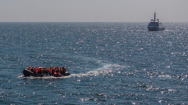 A French warship escorts an inflatable boat carrying migrants across the English Channel near Dover, on the south coast of England. Getty Images
