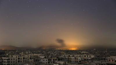 Lights and smoke are seen during Syrian government bombardment on the rebel-controlled town of Arbin, in the besieged Eastern Ghouta region on the outskirts of the capital Damascus. Ammar Suleiman / AFP