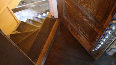 The doorway and stairs to the basement of the house. AP