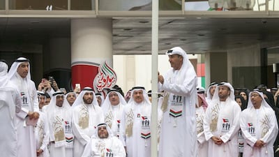 Hussain Lootah, director general of Dubai Municipality, leads the flag-raising ceremony with other dignitaries. Jeffrey E Biteng / The National