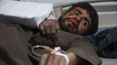 An injured man receives treatment. EPA