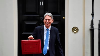 British Finance Minister Philip Hammond poses for pictures with the Budget Box as he leaves 11 Downing Street in London. AFP