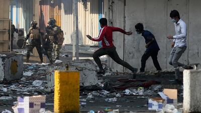 Iraqi security forces try to disperse anti-government protesters in downtown, Baghdad. AP Photo
