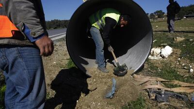 Workers lay a pipeline along the side of a road in Turkish northern Cyprus, between Panagra village and divided capital Nicosia on February 5. The pipeline is part of a project now under construction to send water from the Turkish mainland to the breakaway north of ethnically split Cyprus. Petros Karadjias / AP