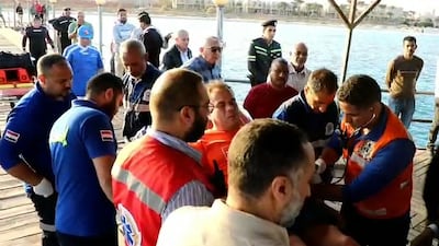 First responders tend to a man on a stretcher in Marsa Alam on Monday. AFP