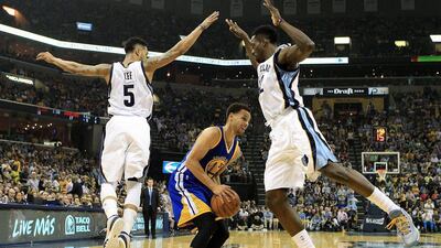 Courtney Lee, left, and Jeff Green, right, of the Memphis Grizzlies, defend against Stephen Curry of the Golden State Warriors during their NBA play-offs game on Saturday night. Mike Brown / EPA / May 9, 2015