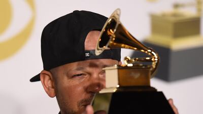 Recording artist Residente, winner of the Best Latin Rock, Urban or Alternative Album award for 'Residente,' poses in the press room. AFP