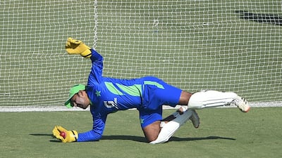 Pakistan's Sarfaraz Ahmed takes a catch during training. AFP