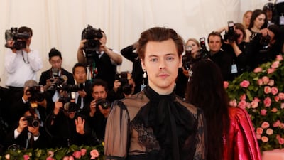 Harry Styles wore high waisted black trousers and a sheer black shirt, with cravat to the Met Gala. Reuters