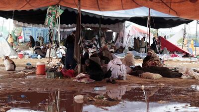 Supporters take shelters in a camp as it rains during the sixth day of protest. EPA