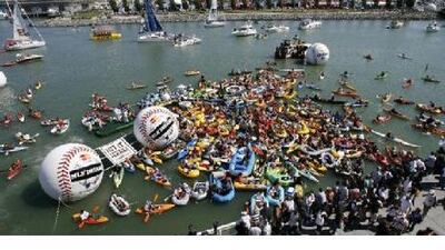 Spectators sit in their rafts and kayaks in McCovey Cove, outside the stadium in San Francisco, waiting for home runs.