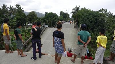 Filipino villagers view a damaged bridge in the earthquake-hit city of Surigao. EPA/CERILO EBRANO