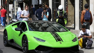 A Lamborghini supercar, illegally parked in Knightsbridge, London, is about to receive a ticket. Stephen Lock / The National