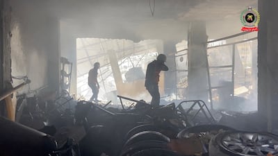 Rescuers look for survivors and bodies inside a destroyed building in Khan Younis. Reuters
