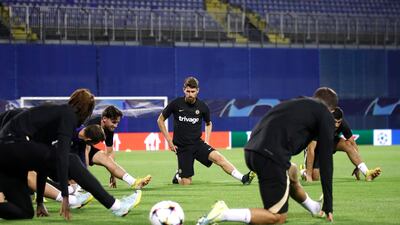 Chelsea midfielder Jorginho, centre, stretches alongside teammates. EPA