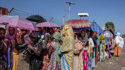 Tigray women who fled the conflict in the Ethiopia's Tigray region, wait for UNHCR to distribute blankets at Hamdayet Transition Center, eastern Sudan. AP Photo
