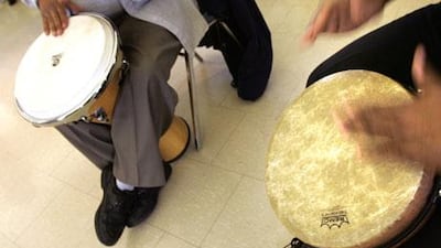 Volunteers bang out some rhythms during Drum Circle, a music-therapy class held for employees at a hospital in the US.