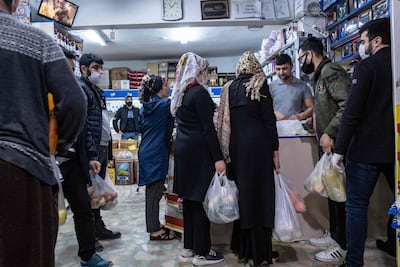 People queue at shops before a two-day lockdown began in Istanbul and other Turkish cities on April 10, 2020. AFP