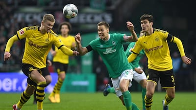 Erling Haaland, left, contests a ball with Bremen's Niklas Moisander. EPA