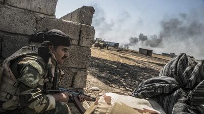 Peshmerga take cover during an operation to liberate several ISIL-held villages south-east of Mosul on August 14, 2016. Andrea Dicenzo / EPA