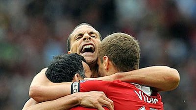 Rio Ferdinand lets out a cry of joy with his Manchester United teammates at Old Trafford after beating Chelsea.