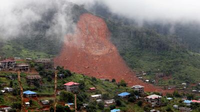 A mudslide buries part of the mountain town of Regent in Sierra Leone on Monday. Afolabi Sotunde / Reuters