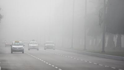 Cars drive through the morning fog on 24th street in Abu Dhabi in 2009. Galen Clarke / The National