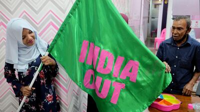 Workers of Maldives President Mohammed Muizzu display a flag with the slogan 'India Out', in the capital Male. Reuters