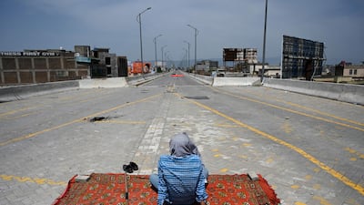 A supporter of Tehreek-e-Labbaik Pakistan keeps watch as others protest against the arrest of their leader who has called for the expulsion of the French ambassador in Rawalpindi. AFP