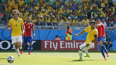 Alexis Sanchez of Chile, fari right, scores the equaliser to make it 1-1 against as Thiago Silva of Brazil, second right, looks on during the 2014 World Cup on Saturday in Belo Horizonte, Brazil. Dennis Sabangan / EPA