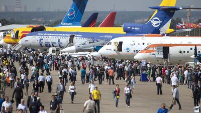 Visitors walk past a lineup of Russian aircraft during the MAKS 2015. Pavel Golovkin / AP Photo