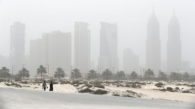 People at the Jumeirah open beach during the sandstorm in Dubai. Pawan Singh / The National