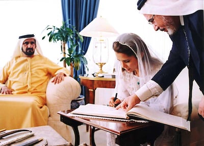 Princess Haya, King Abdullah II's half-sister, signs her wedding register to Dubai's then Crown Prince and Defence Minister Sheikh Mohammed bin Rashid at Baraka Palace in Amman, Jordan, Saturday April 10, 2004. AP / Royal Palace
