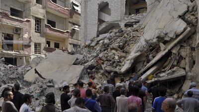 Residents inspect a site hit by what activists said were barrel bombs thrown by forces loyal to Syria's president Bashar Al Assad, in the Palestinian Yarmouk refugee camp, on the outskirts of Damascus May 26. Reuters