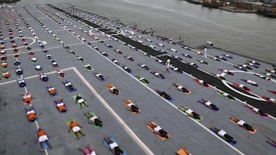 Indian armed forces and their families members perform Yoga on the deck of the Indian Naval aircraft carrier Viraat to mark International Yoga Day in Mumbai, India. Rajanish Kakade / AP photo